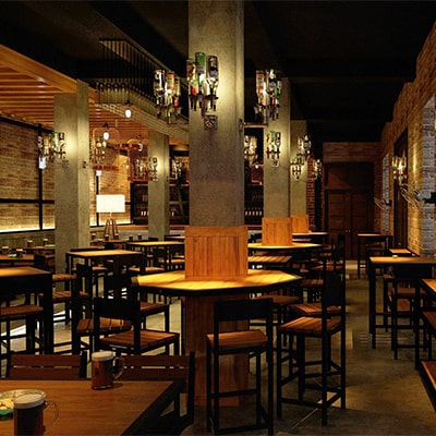 Interior view of Angel's Grill House with wooden tables and brick walls